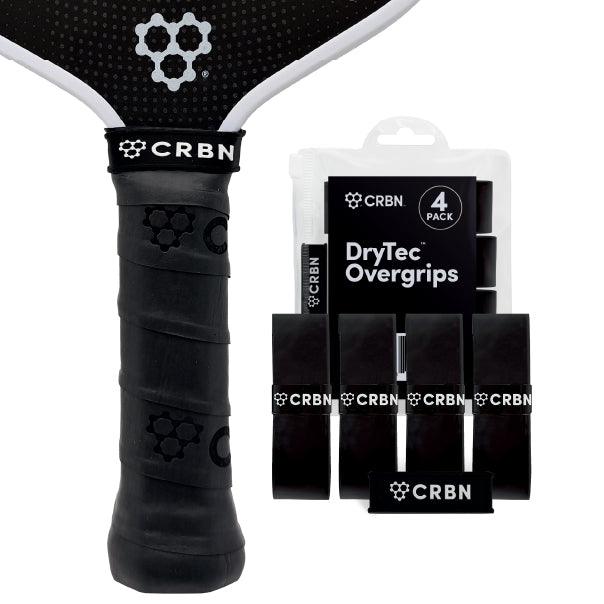 CRBN DryTec Overgrips 4-Pack in Black, wrapped on a pickleball paddle handle beside the packaging