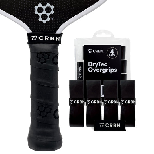 CRBN DryTec Overgrips 4-Pack in Black, wrapped on a pickleball paddle handle beside the packaging