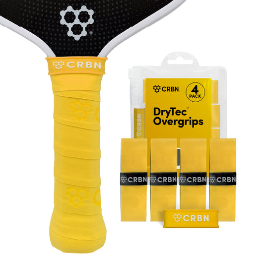 CRBN DryTec Overgrips 4-Pack in Yellow, wrapped on a pickleball paddle handle beside the packaging