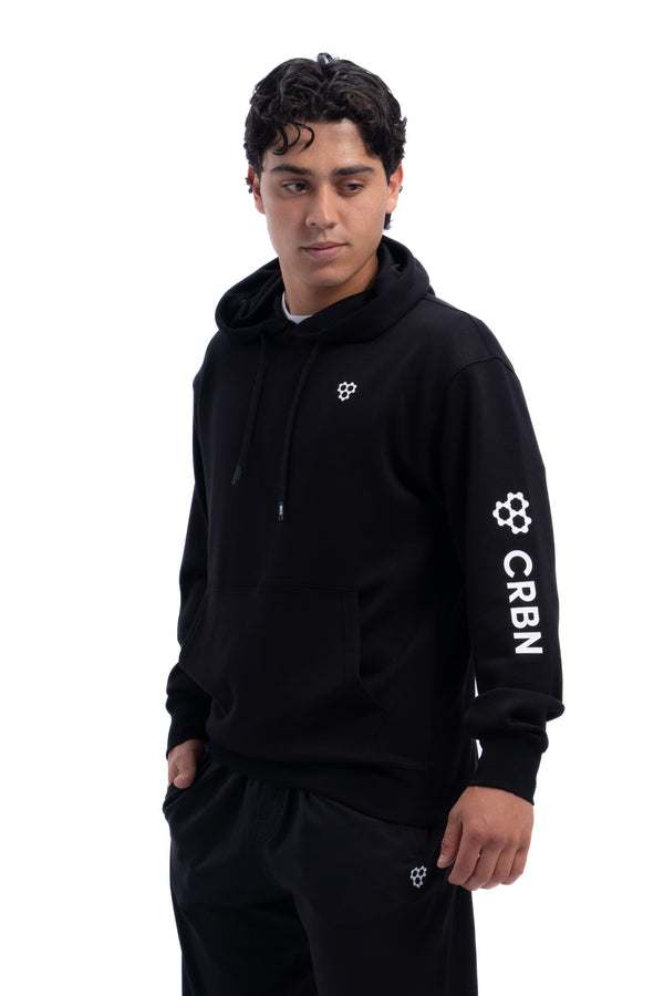 Model in black Men’s CourtIQ Performance Hoodie with small chest logo and CRBN on the sleeve