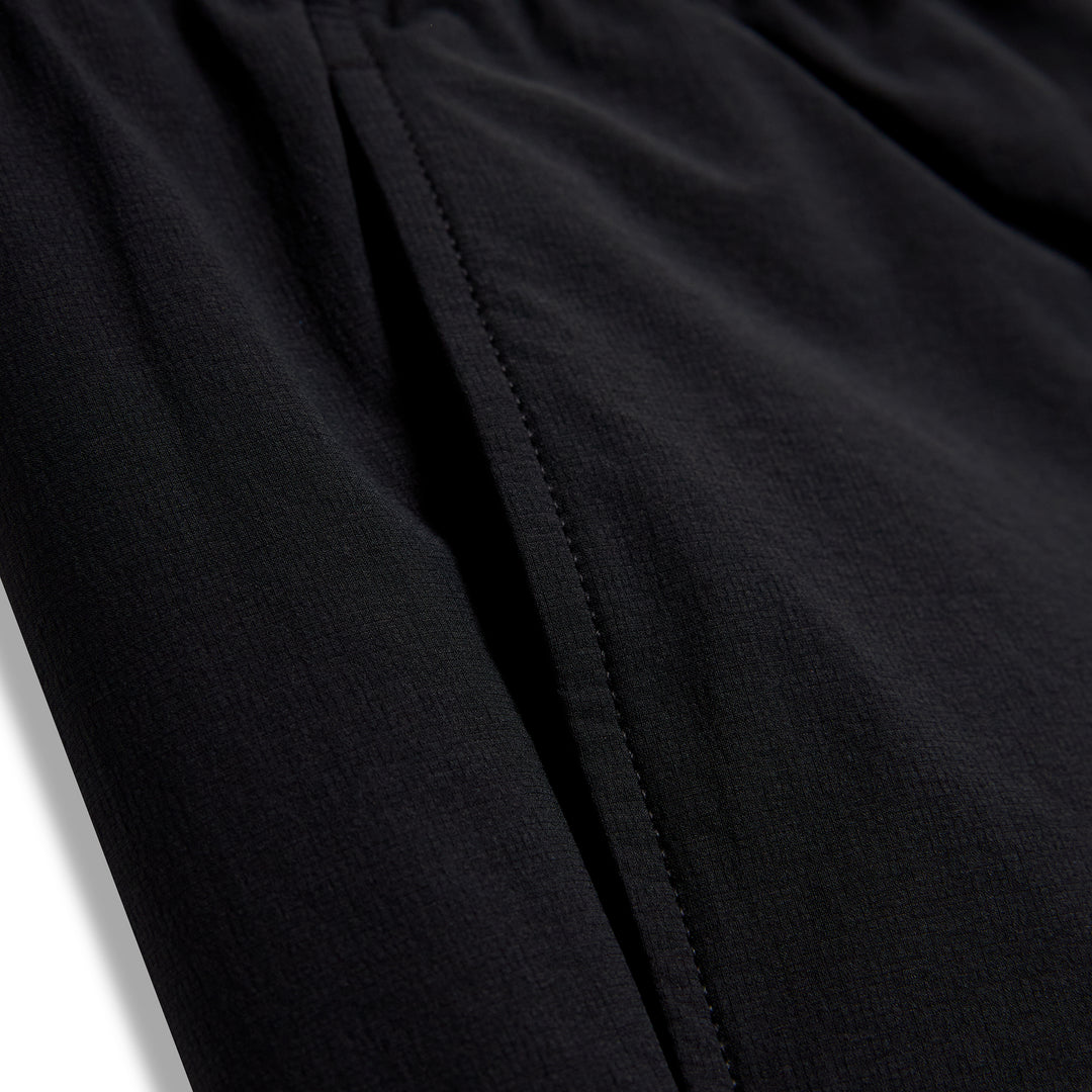 Close-up of black fabric with a vertical seam on CRBN x Florence Marine X Airtex Utility Short
