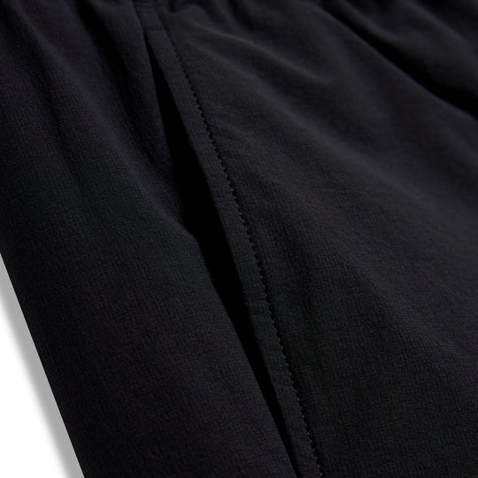 Close-up of black fabric with a vertical seam on CRBN x Florence Marine X Airtex Utility Short