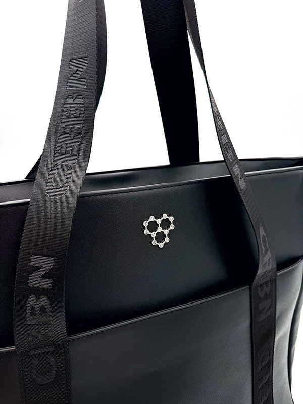 Black CRBN Club Pickleball Tote Bag with wide branded straps and a silver molecule logo on the front