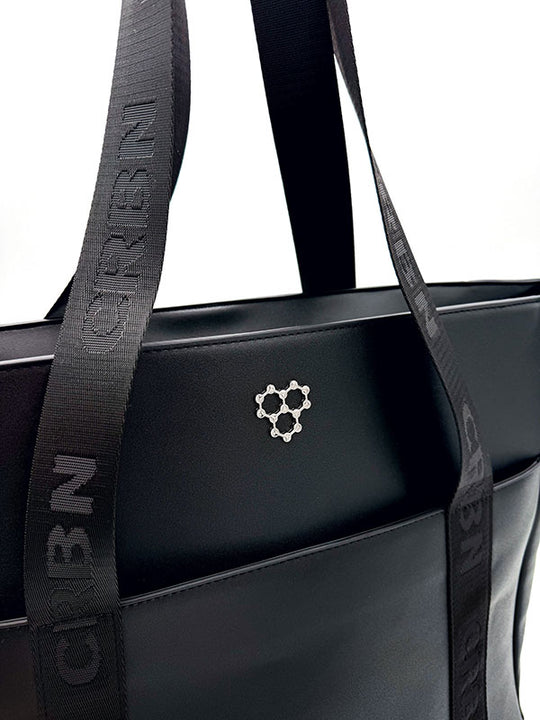 Black CRBN Club Pickleball Tote Bag with wide branded straps and a silver molecule logo on the front